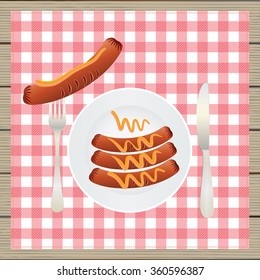 Sausages on a plate. Sausage, mustard, plate, fork, knife, table. Top view.