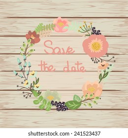 Save the date floral card on wooden background. Cute retro flowers arranged un a shape of the wreath perfect for wedding invitations and birthday cards. Vector illustration