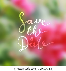 save the date lettering, vector handwritten text on blurred floral background