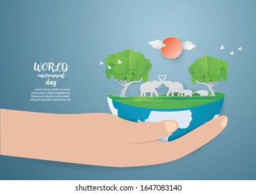 Save Wildlife and World environment day with Elepant family in green forest on hand,paper craft modern style.