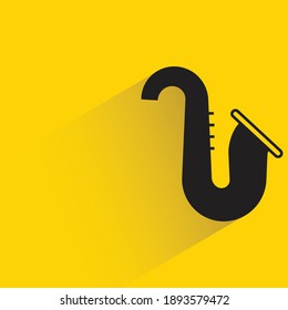 saxophone with shadow on yellow background