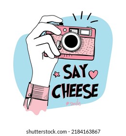 Say cheese slogan text and hands holding camera drawing, design for fashion graphics, t shirt prints, posters, stickers etc