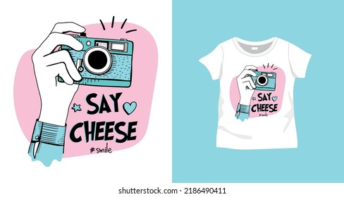 Say cheese slogan text and hands holding camera drawing, design for fashion graphics, t shirt prints, posters, stickers etc