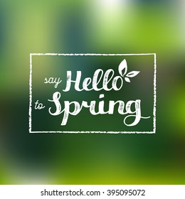 Say hello to spring vector illustration on blur green background. Vector hand lettering inspirational typography for logo or label.