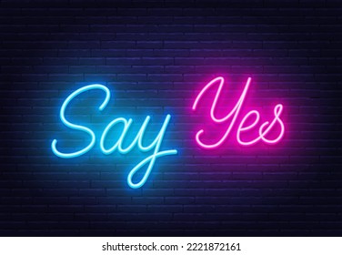 Say Yes neon quote on brick wall background.