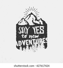 Say yes to new adventures! Vintage wilderness logo on mountains background. Vector mountains shield.