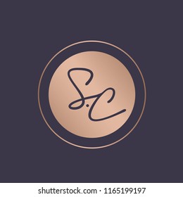 SC circular monogram.Emblem style logo with letter s and letter c.Hand drawn lettering icon in rose gold metallic color isolated on dark background.