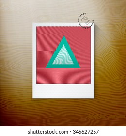 Scalable Eps10 Vector Turquoise Triangles Composition on a Retro Photo Paper Placed on a Wooden Surface