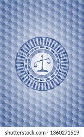 scale icon inside blue badge with geometric pattern.