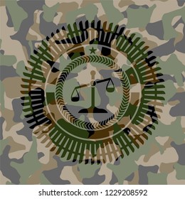 scale icon inside camouflage emblem