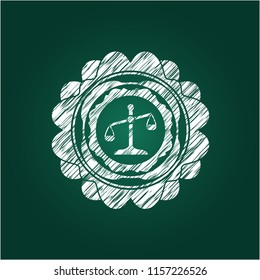 scale icon inside chalkboard emblem