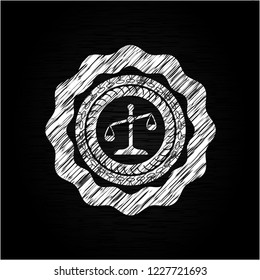 scale icon inside chalkboard emblem written on a blackboard