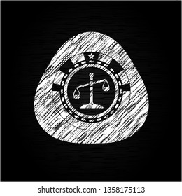 scale icon inside chalkboard emblem