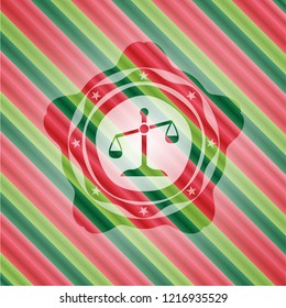 scale icon inside christmas colors emblem.