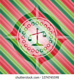 scale icon inside christmas colors emblem.