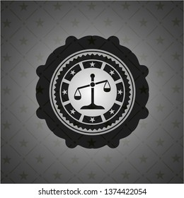 scale icon inside dark emblem