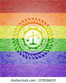scale icon inside emblem on mosaic background with the colors of the LGBT flag