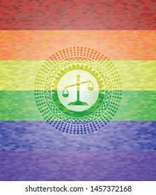 scale icon inside emblem on mosaic background with the colors of the LGBT flag