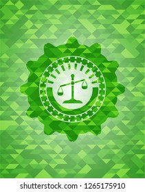 scale icon inside green emblem with mosaic background