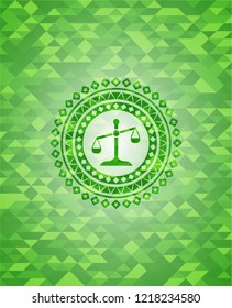 scale icon inside green mosaic emblem