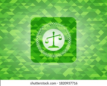 scale icon inside green mosaic emblem. 
