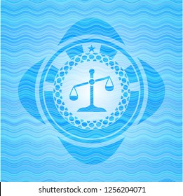 scale icon inside light blue water wave style badge.