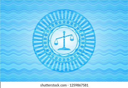 scale icon inside light blue water wave emblem.
