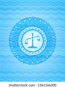 scale icon inside light blue water badge.