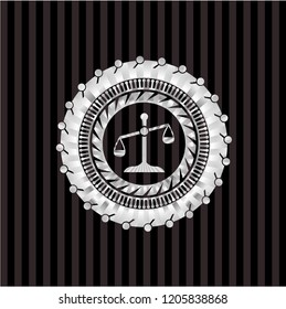scale icon inside silvery emblem