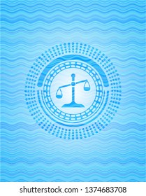 scale icon inside sky blue water wave emblem background.