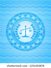 scale icon inside water emblem background.