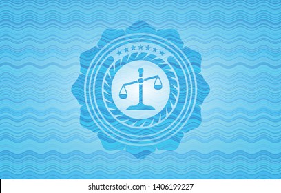 scale icon inside water wave emblem.
