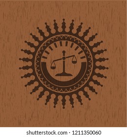 scale icon inside wooden emblem