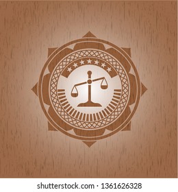 scale icon inside wooden emblem