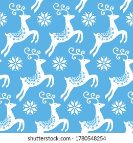 Scandinavian folk art Christmas vector pattern, Nordic white seamless design with reindeer and snowflakes on blue background. Xmas deer cute vector textile design, Norwegian repetitive background