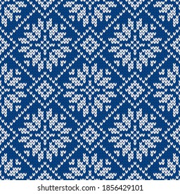 Scandinavian knitted seamless pattern. Norwegian native style sweater with snowflakes. Wool texture. Winter holiday background. Vector illustration.