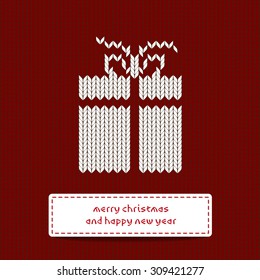Scandinavian style knitted background with gift box in red color 