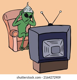 Scared alien with a foil cap watching tv.