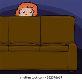 Scared red haired child looking from behind sofa
