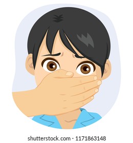 Scared young boy with adult male hand covering his mouth abuse concept