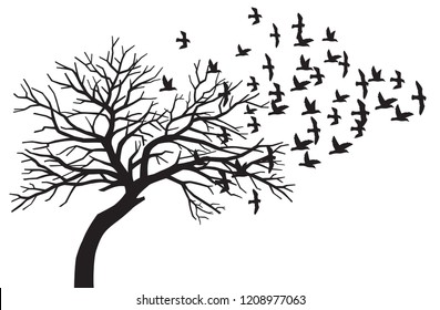 scary bare black tree silhouette and flock of flying birds