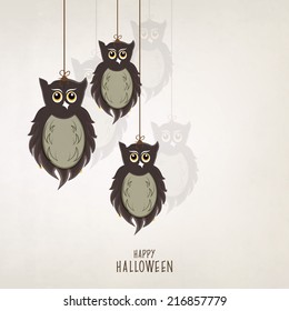 Scary owls hanging by threads on grey background, poster, banner or flyer for Halloween night party celebrations. 