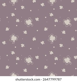 Scattered clovers and playful dots resting on a soft mauve backdrop. Chic minimal clover seamless pattern with simple mauve background. 