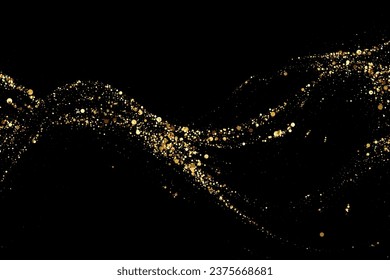 Scattered gold particles on a dark background. A wavy stream of shiny gold confetti. Festive background or design element