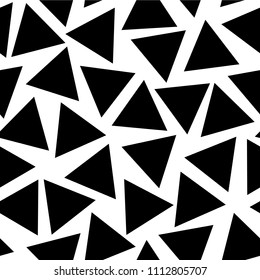 Scattered randomly placed black triangles on a white background. Seamless vector pattern.