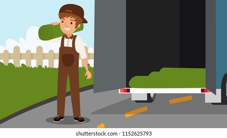 The scene of a man taking fake lawn out of the back of a truck.
