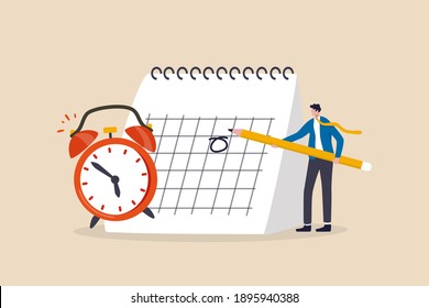 Schedule business appointment, important date, working project plan or reminder concept, smart businessman using pencil to mark important appointment date on calendar with alarm clock.