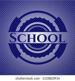 School badge with denim background