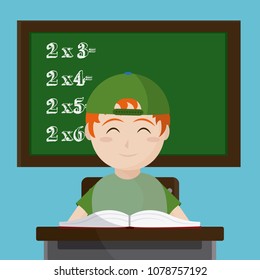 School boy seated at desk