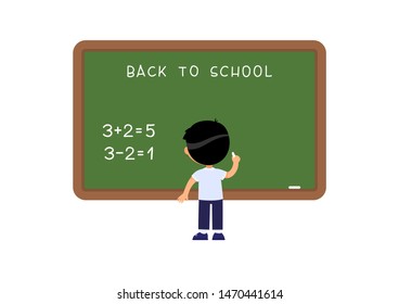 School Boy standing near blackboard. Elementary school pupil solving mathematical exercise. Addition and subtraction task on math lesson